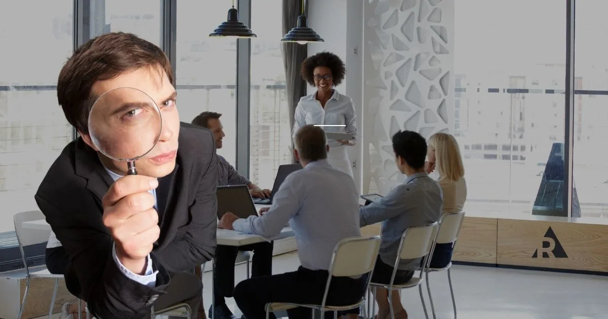 Employee observing a team meeting, representing workplace transparency and open communication.