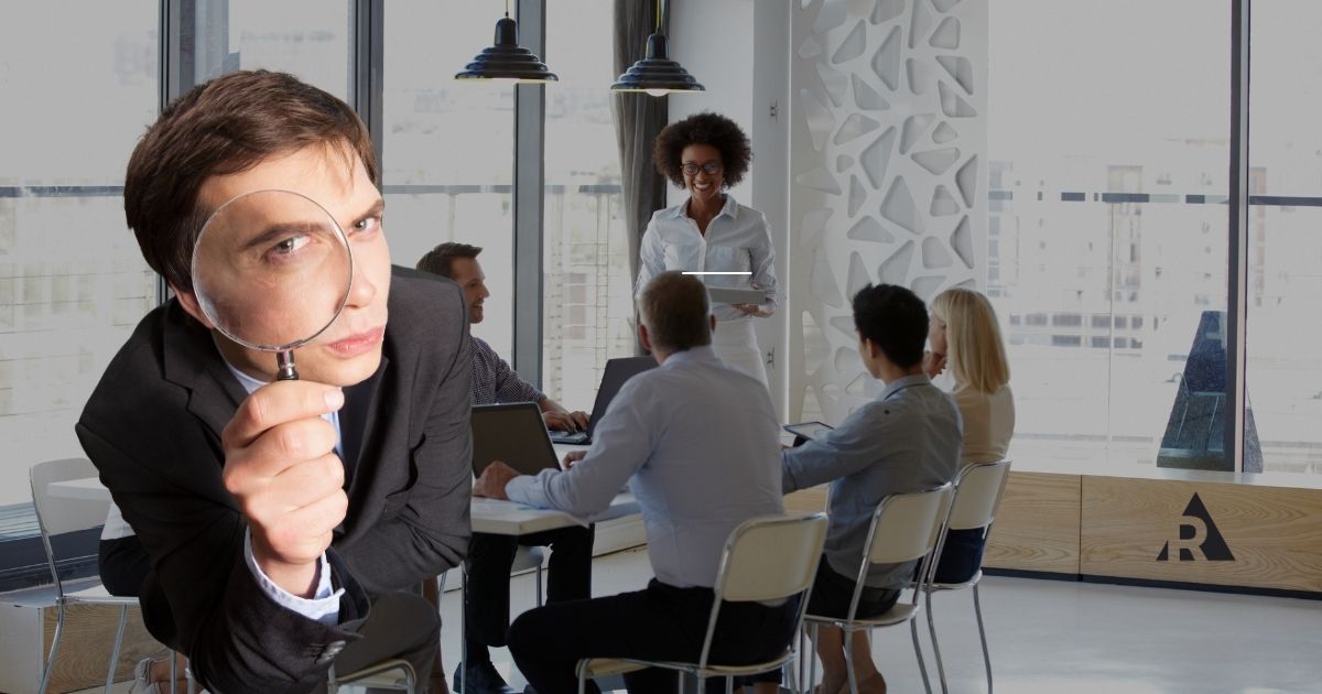 Employee observing a team meeting, representing workplace transparency and open communication.