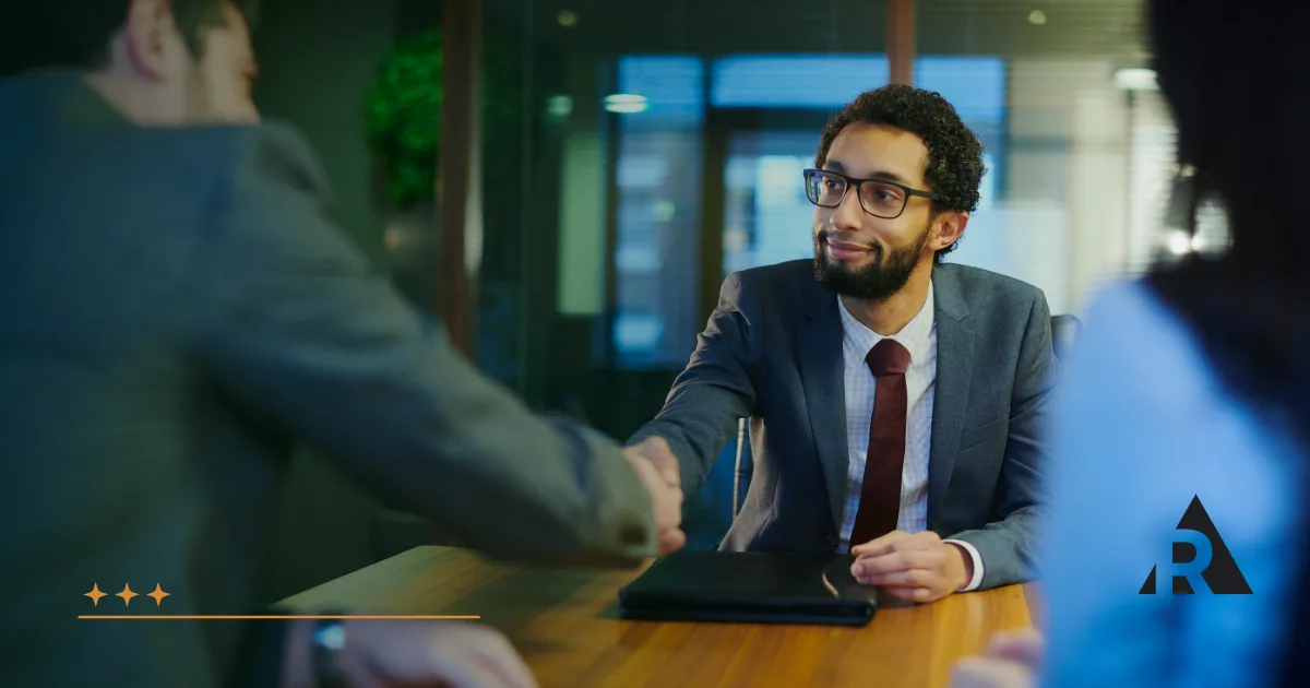 two men shaking hands representing getting your first Scrum Master job