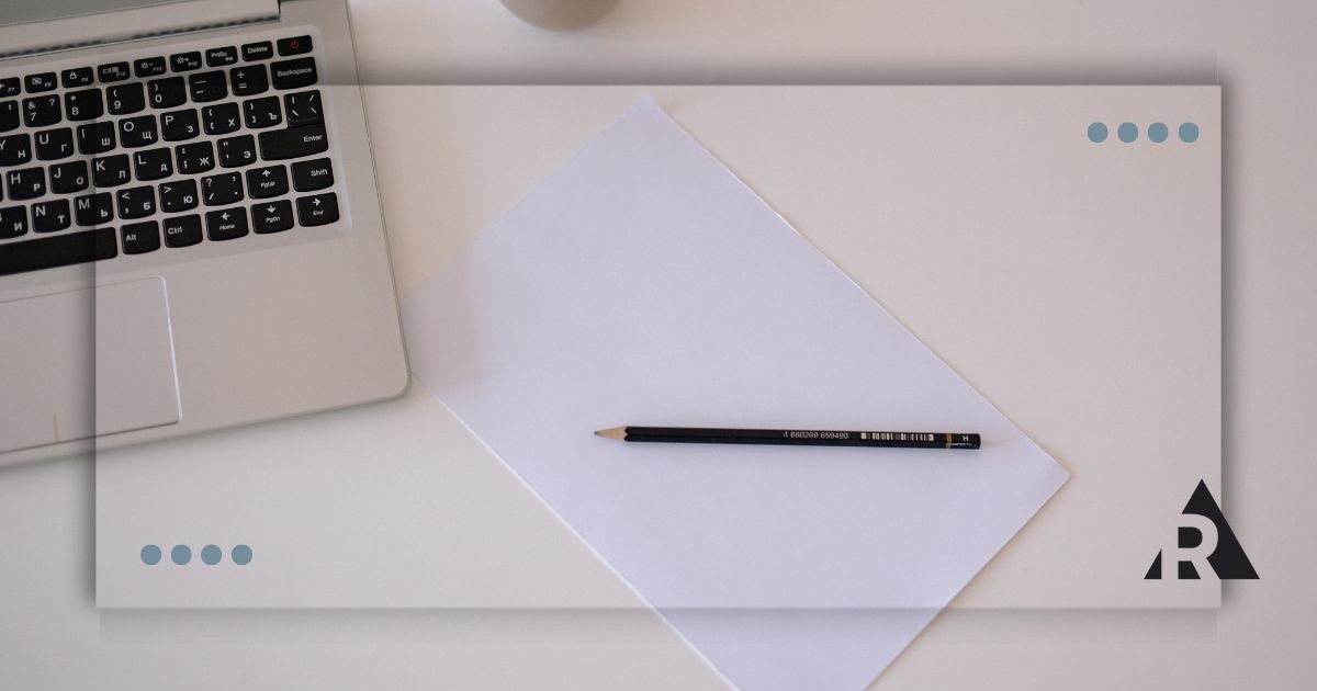 Pen and paper with a laptop