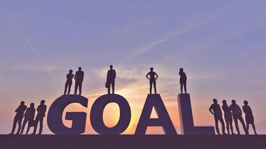 business people standing on the word goal