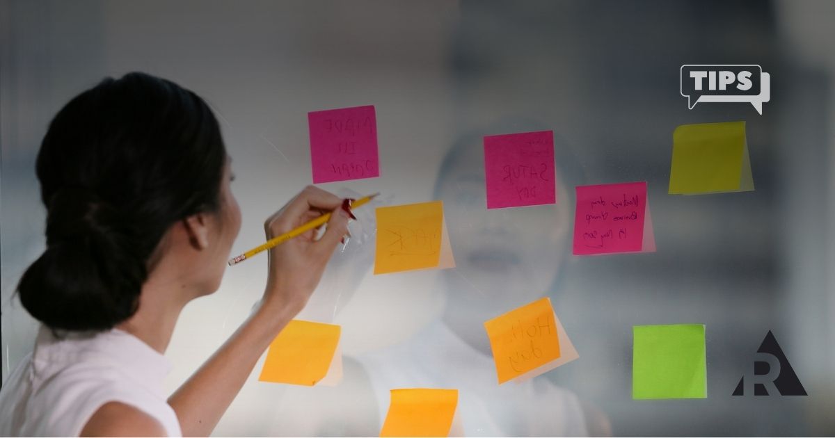 Women organizing backlog with sticky notes