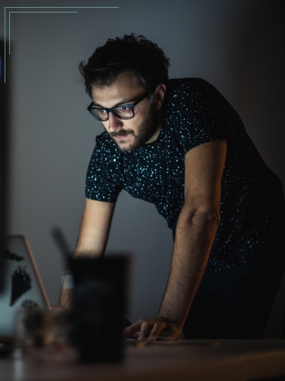 man at computer man in office looking at screen