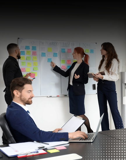 Group of Colleagues Discussing Kanban board