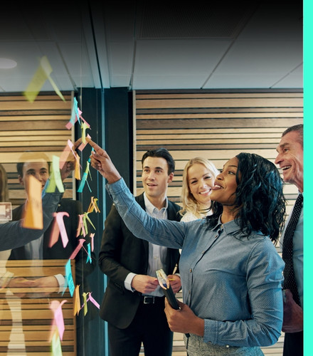 Women with team working on a board with sticky notes